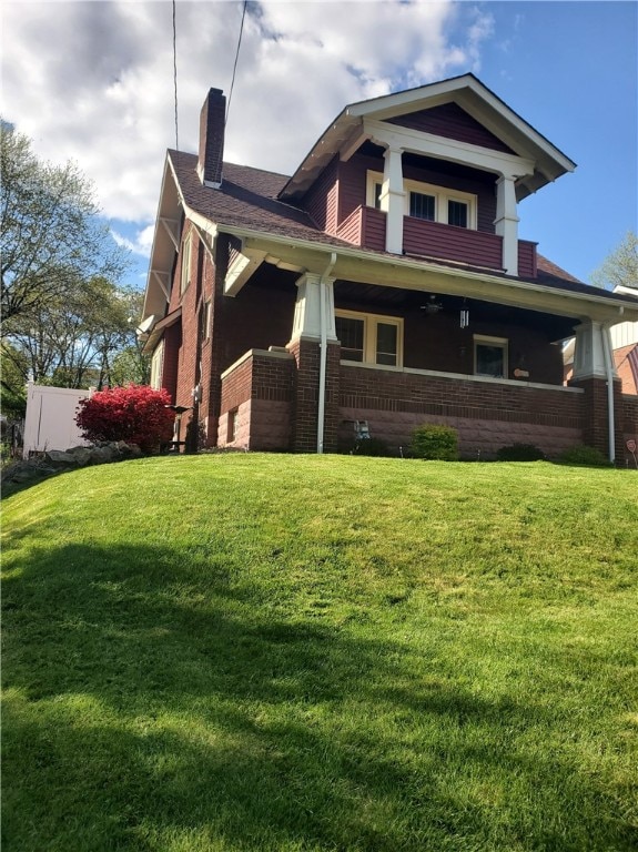 back of house featuring a yard