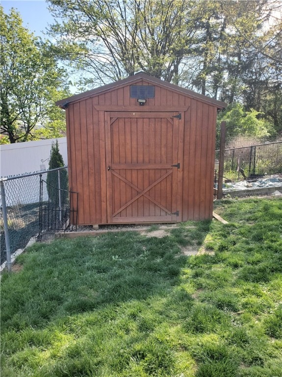 view of outbuilding with a lawn