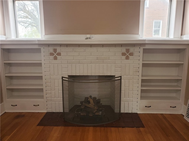 room details with a brick fireplace and hardwood / wood-style floors