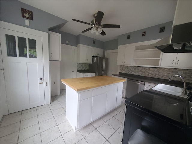 kitchen featuring appliances with stainless steel finishes, sink, wooden counters, white cabinets, and exhaust hood