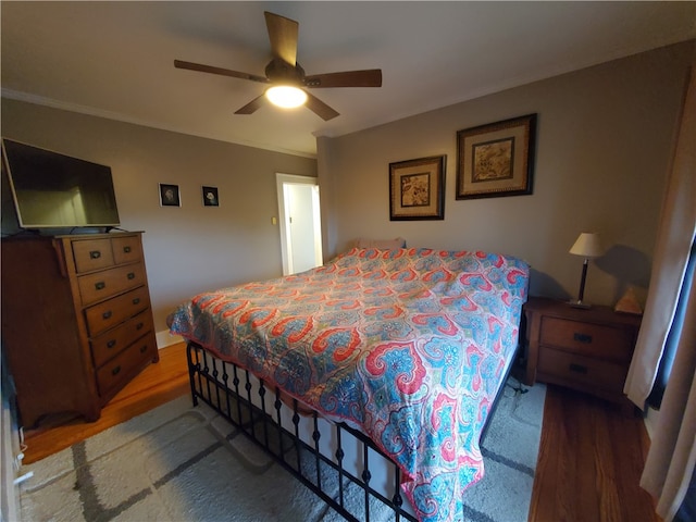 bedroom with ornamental molding, dark hardwood / wood-style floors, and ceiling fan