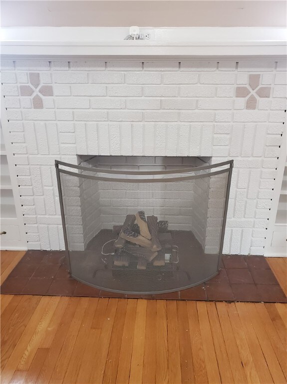 details with hardwood / wood-style floors and a fireplace