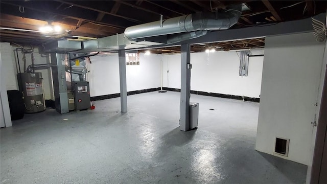 basement featuring water heater and heating unit