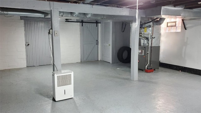 basement with heating unit and a barn door