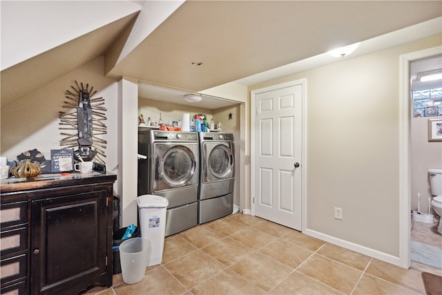 washroom with separate washer and dryer and light tile patterned floors