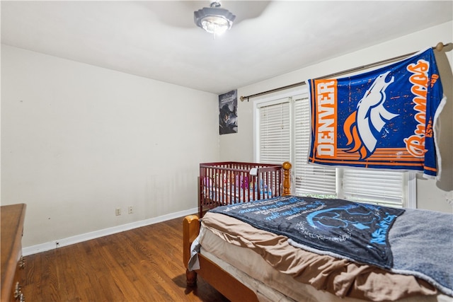 bedroom with dark wood-type flooring