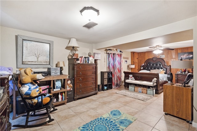 tiled bedroom featuring ceiling fan