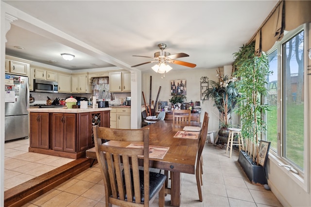 dining area with ceiling fan and light tile patterned flooring