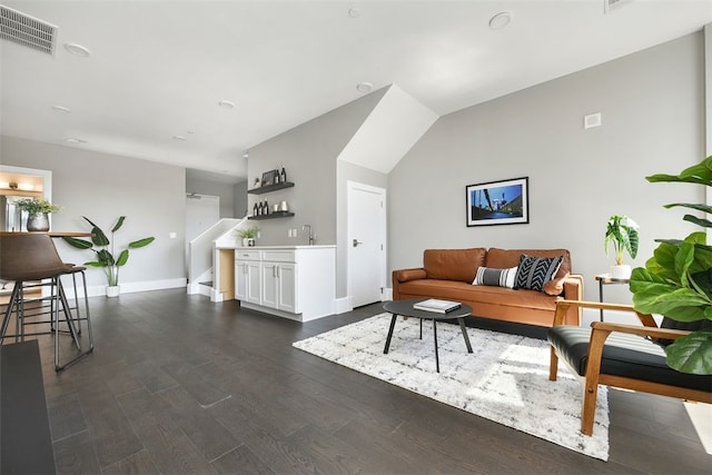 interior space featuring dark hardwood / wood-style flooring and vaulted ceiling