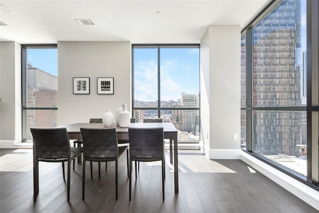 dining space featuring light hardwood / wood-style floors and a wall of windows