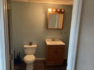 bathroom featuring hardwood / wood-style flooring, toilet, and vanity