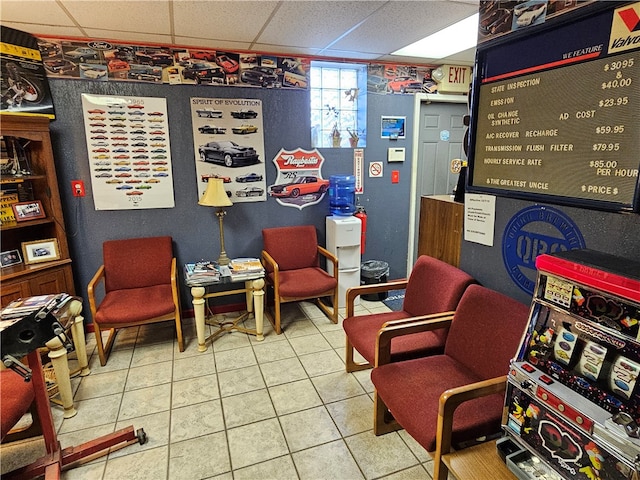 interior space with a drop ceiling and tile floors