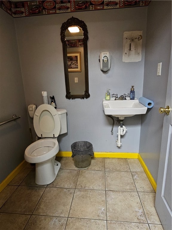 bathroom featuring toilet and tile floors