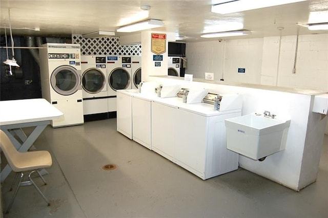 clothes washing area with sink and washer and clothes dryer