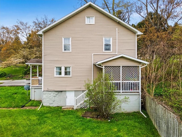 rear view of house featuring a lawn