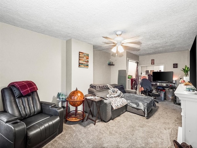 carpeted living room with ceiling fan and a textured ceiling