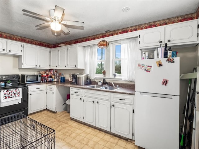 kitchen with ceiling fan, light tile floors, black range with electric stovetop, sink, and white refrigerator