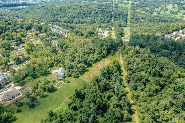 drone / aerial view featuring a forest view