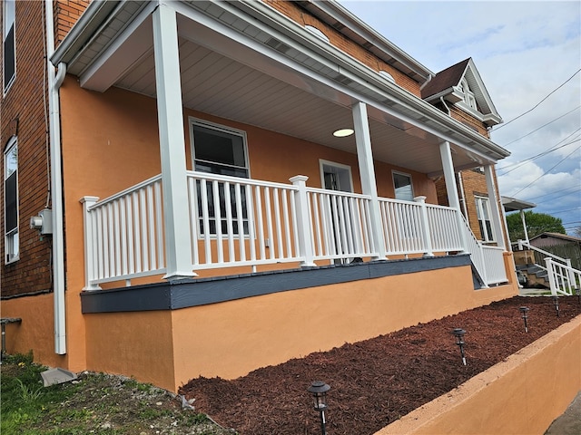 view of side of property with a porch