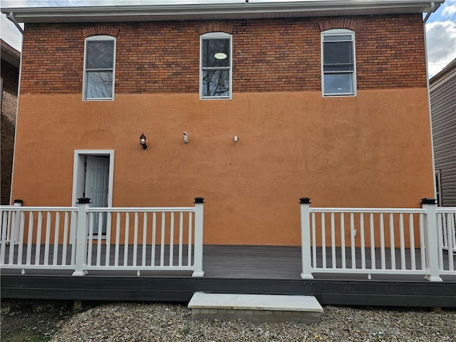 back of property with a wooden deck