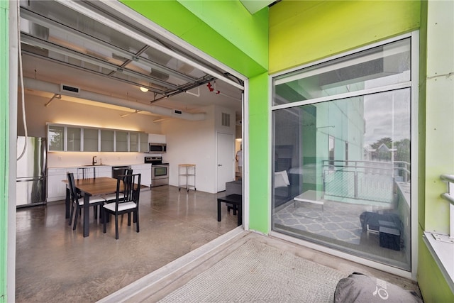 interior space featuring concrete flooring and sink