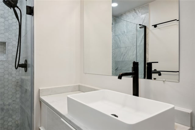 bathroom featuring vanity and a tile shower