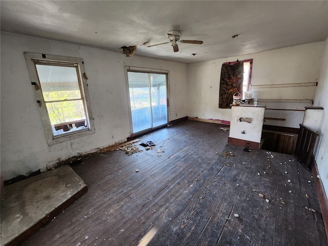 unfurnished living room with ceiling fan and hardwood / wood-style flooring