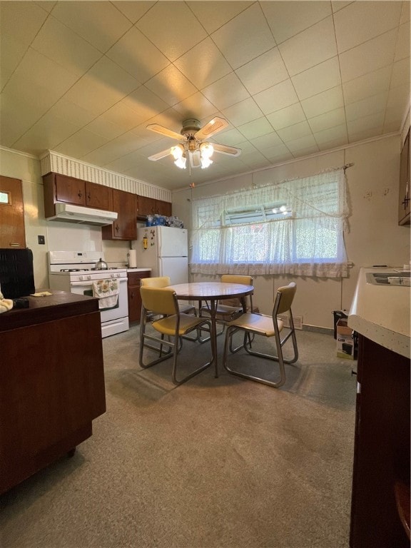 dining area with ceiling fan and carpet floors