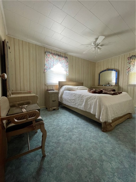 carpeted bedroom featuring ceiling fan and crown molding