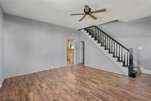 unfurnished living room featuring hardwood / wood-style floors and ceiling fan