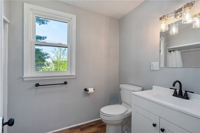 bathroom featuring vanity, hardwood / wood-style floors, and toilet