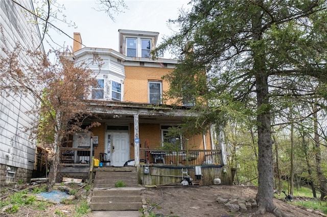 italianate home featuring covered porch