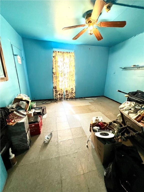 misc room featuring tile floors and ceiling fan