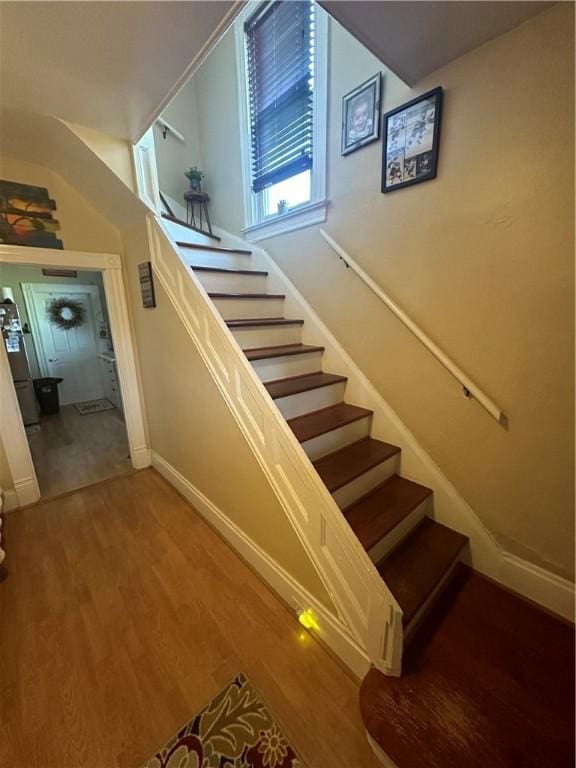 stairs featuring wood-type flooring