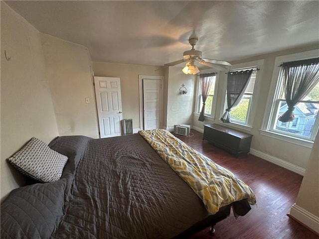 bedroom featuring ceiling fan and dark hardwood / wood-style flooring