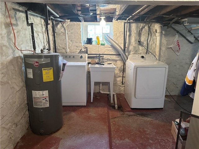 laundry area featuring washing machine and clothes dryer and electric water heater