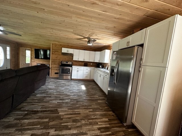 kitchen featuring appliances with stainless steel finishes, ceiling fan, dark wood-type flooring, white cabinetry, and wood ceiling