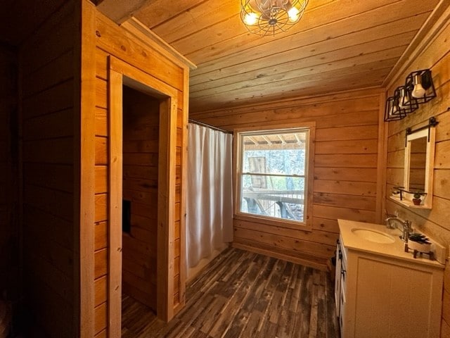 bathroom featuring wooden ceiling, wood walls, vanity, and hardwood / wood-style flooring