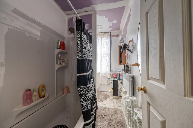 bathroom featuring ornamental molding and tile flooring