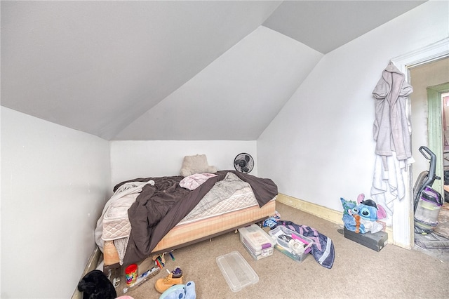 bedroom featuring carpet floors and lofted ceiling