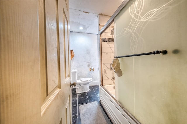 bathroom with tile floors, toilet, and enclosed tub / shower combo