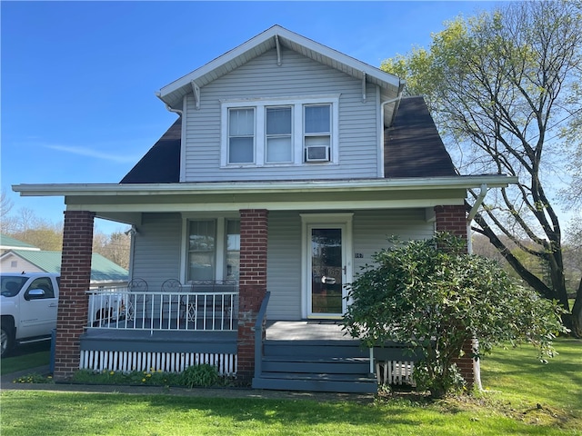 view of front of property with a porch and a front yard