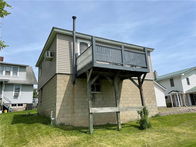 rear view of property with a balcony, a lawn, and a wall mounted AC