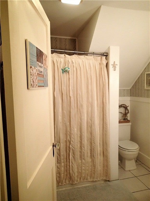 bathroom with toilet and tile floors