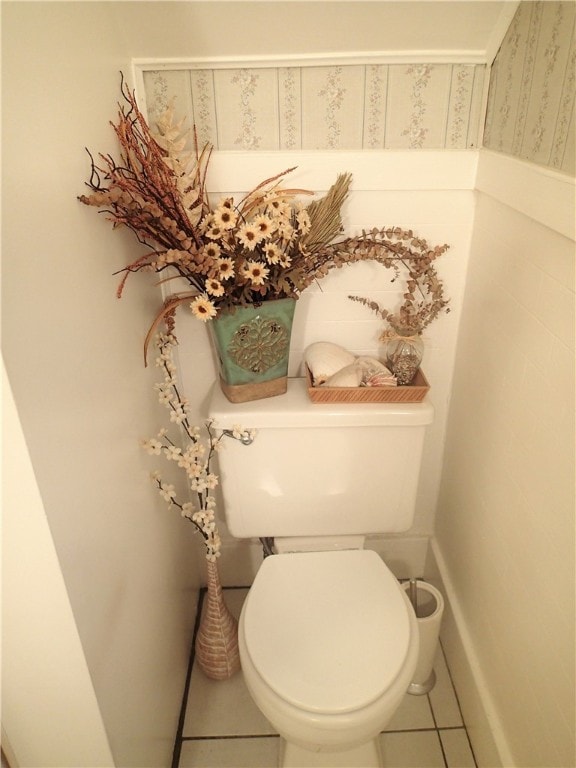 bathroom featuring toilet and tile flooring