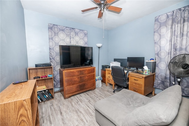 office space with light wood-type flooring and a ceiling fan