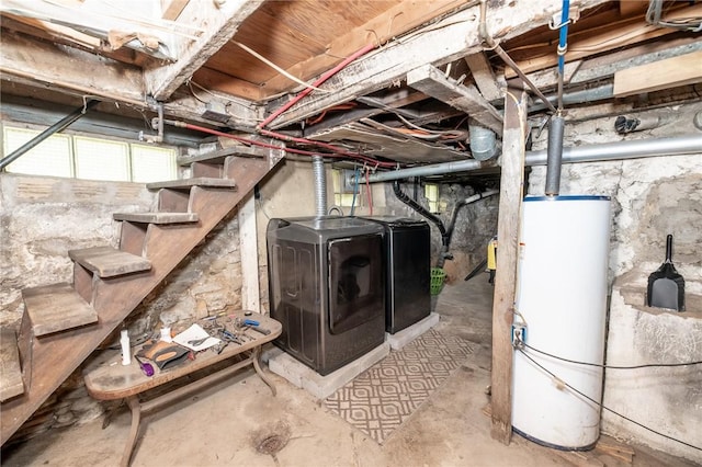 unfinished below grade area featuring washer and clothes dryer and gas water heater