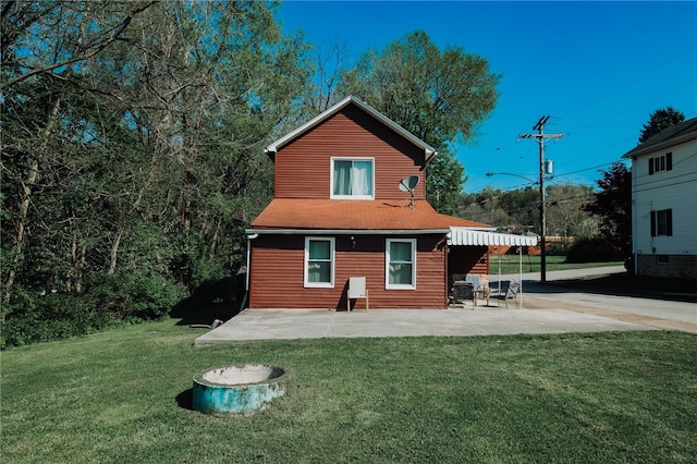 back of house featuring a yard and a patio area