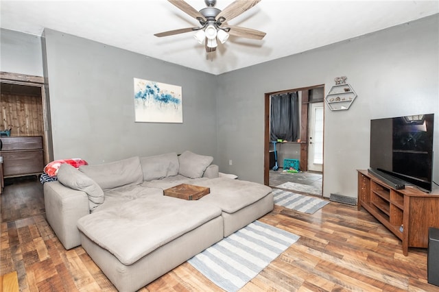 living room with a ceiling fan and wood finished floors