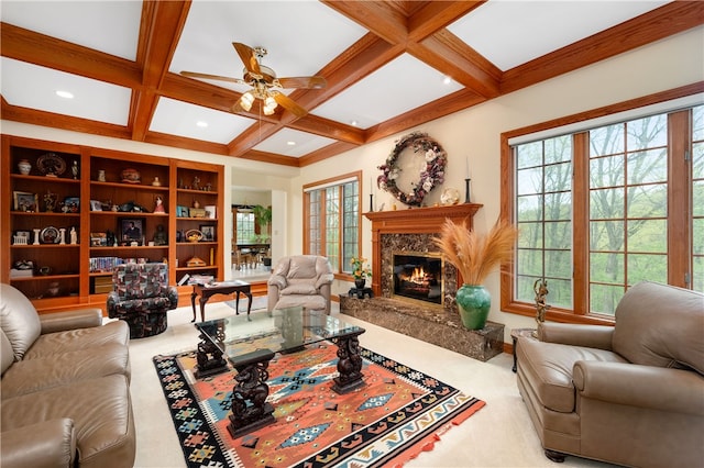 living room featuring coffered ceiling, beam ceiling, a premium fireplace, and carpet